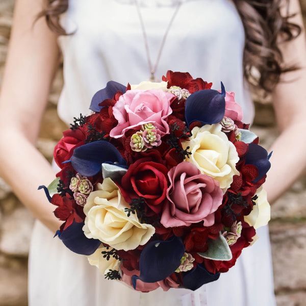 Vintage Bridesmsids burgundy wine bouquet with calla lilies. Roses in cream and mauve with ficus and seeded eucalyptus. Long shops satin ribbon